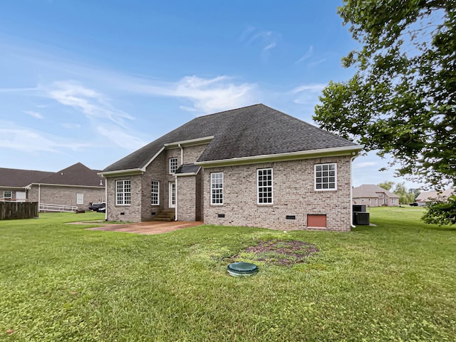 rear view of house featuring central air condition unit, a patio, and a yard