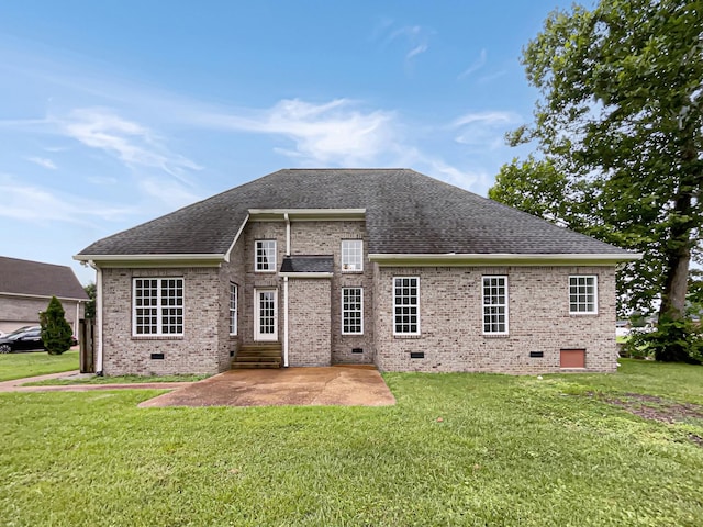 rear view of house with a patio area and a lawn