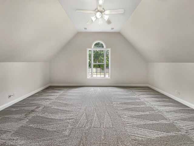 additional living space featuring carpet floors, ceiling fan, and vaulted ceiling