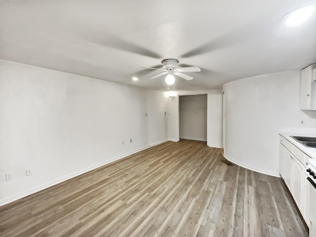 824 N Woodstone Ln, Nashville, TN 37211 - unfurnished living room featuring ceiling fan, light wood-type flooring, a sink, and baseboards
