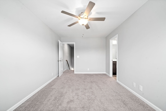 spare room with light carpet, baseboards, and a ceiling fan