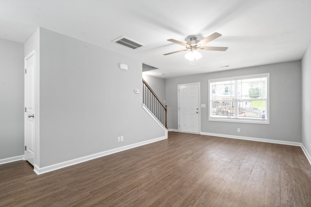 entrance foyer with visible vents, baseboards, ceiling fan, stairway, and dark wood-style flooring