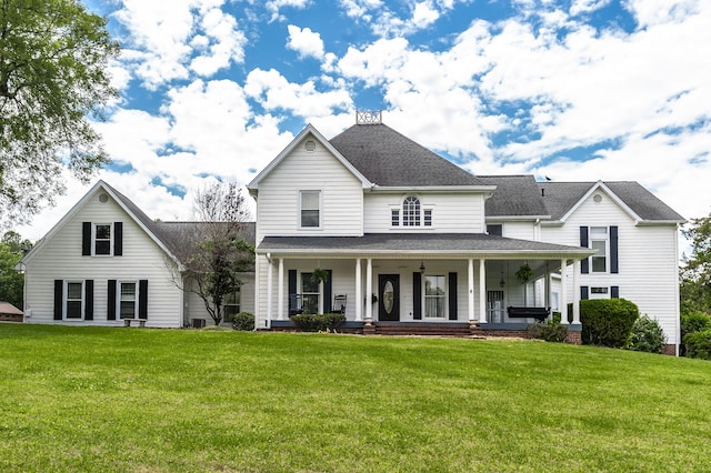 view of front of property with covered porch and a front yard