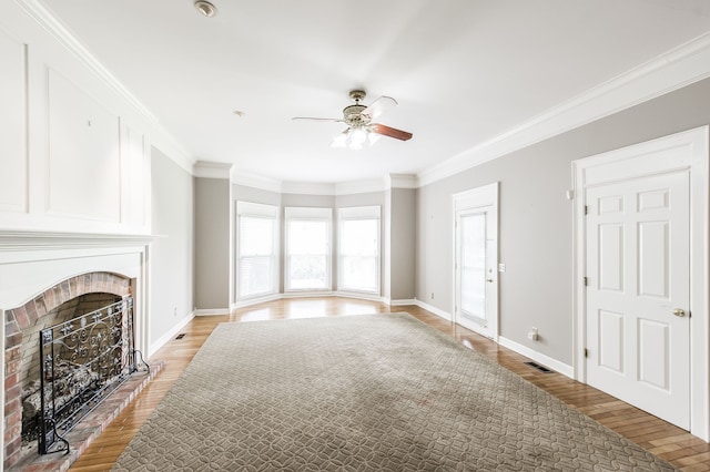 unfurnished living room with ceiling fan, ornamental molding, a fireplace, and light hardwood / wood-style floors