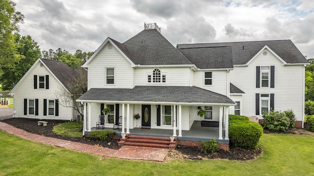 view of front of home featuring a front lawn and a porch