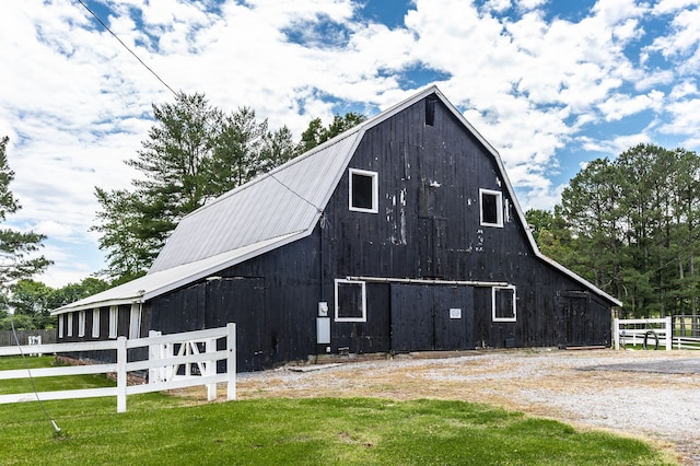 view of property exterior featuring an outbuilding