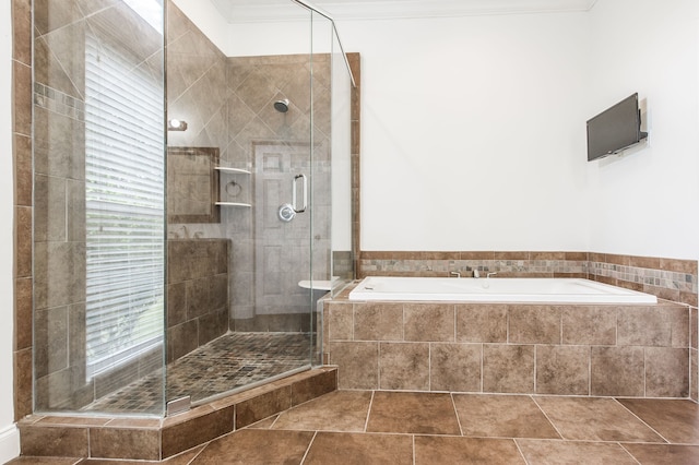 bathroom featuring tile patterned floors, ornamental molding, and shower with separate bathtub