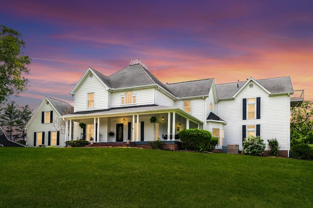 view of front of property featuring a yard and a porch