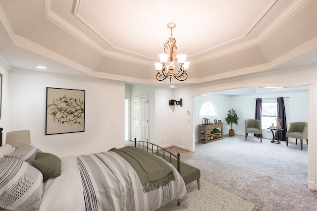 carpeted bedroom with a raised ceiling, crown molding, and an inviting chandelier