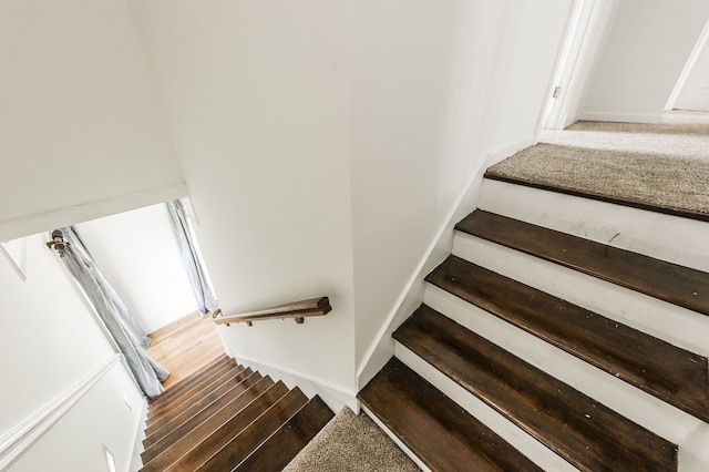 stairs with hardwood / wood-style floors