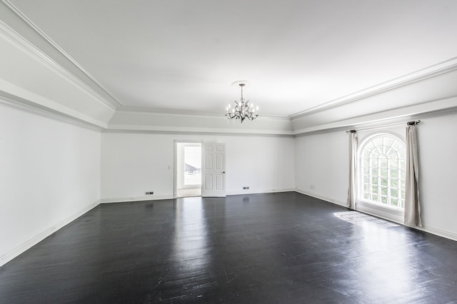 empty room featuring dark hardwood / wood-style flooring, a notable chandelier, and crown molding