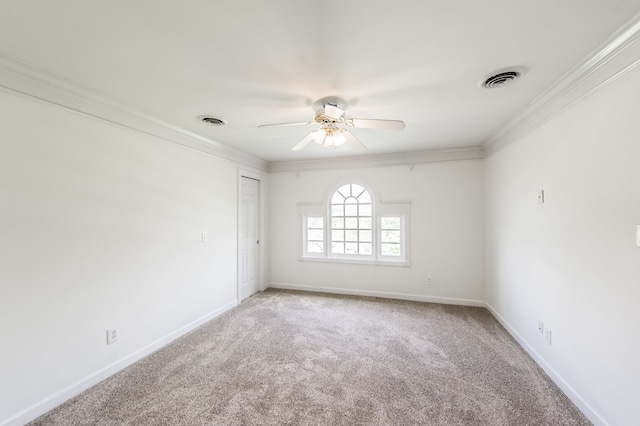 spare room with ornamental molding, carpet floors, and ceiling fan