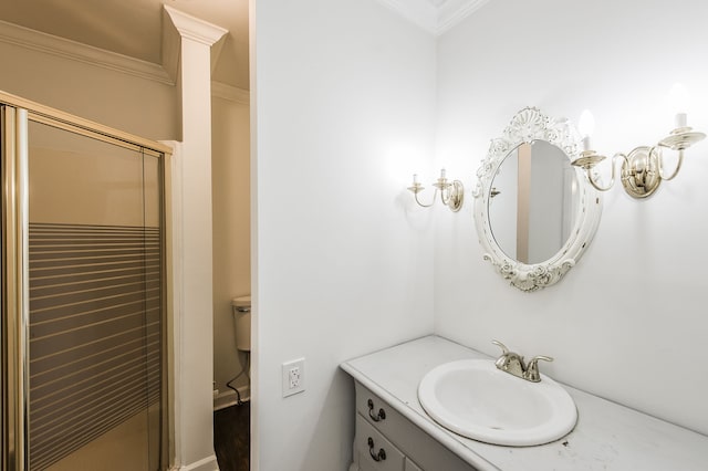 bathroom with crown molding, vanity, and a shower with shower door