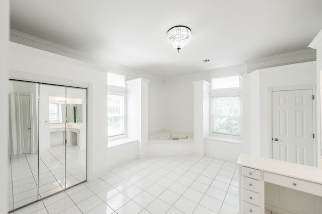 bathroom with tile patterned flooring, a bathtub, and crown molding