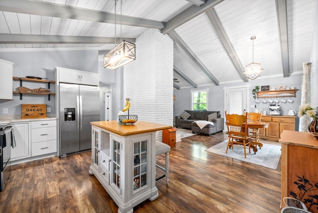 kitchen with appliances with stainless steel finishes, vaulted ceiling with beams, hanging light fixtures, and white cabinetry