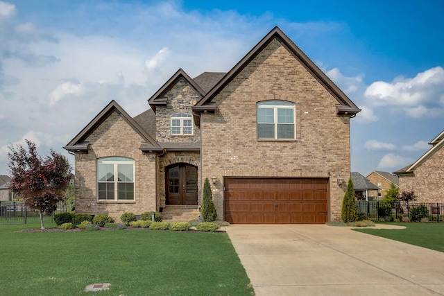 view of front of home with a garage and a front lawn