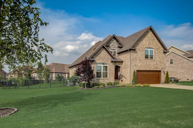 view of front facade with a front yard and a garage