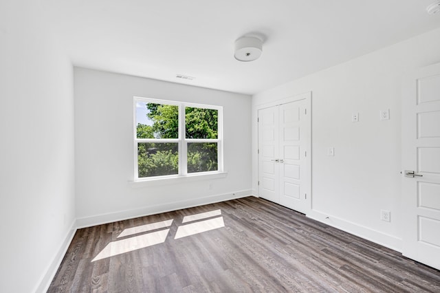 empty room featuring dark hardwood / wood-style flooring