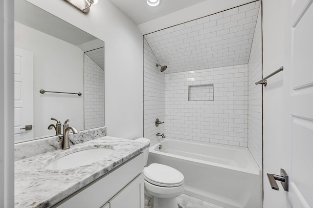 full bathroom with tile flooring, tiled shower / bath, vanity, and toilet