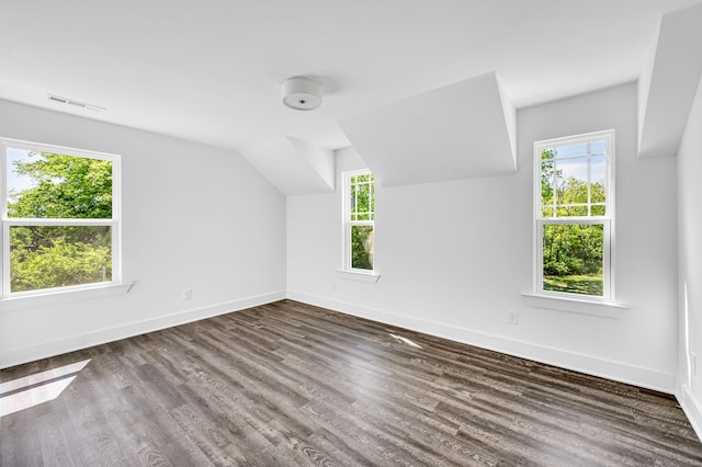 bonus room with vaulted ceiling and dark hardwood / wood-style floors