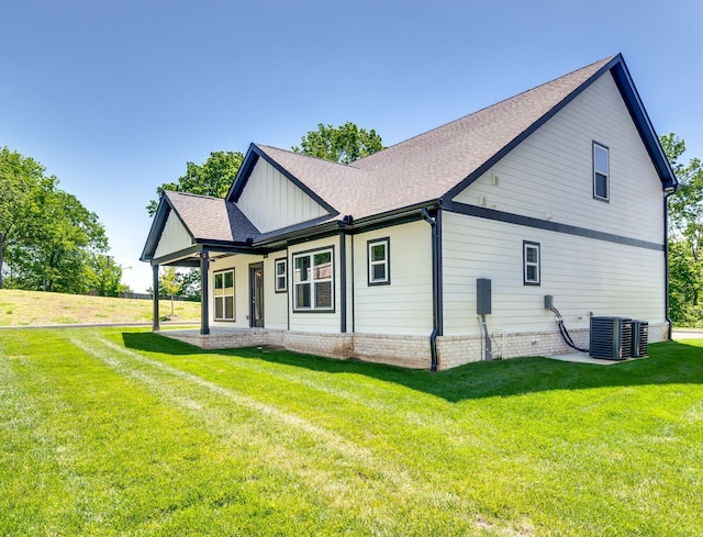 view of home's exterior featuring central air condition unit and a lawn