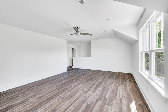 unfurnished living room with dark hardwood / wood-style floors, ceiling fan, and vaulted ceiling