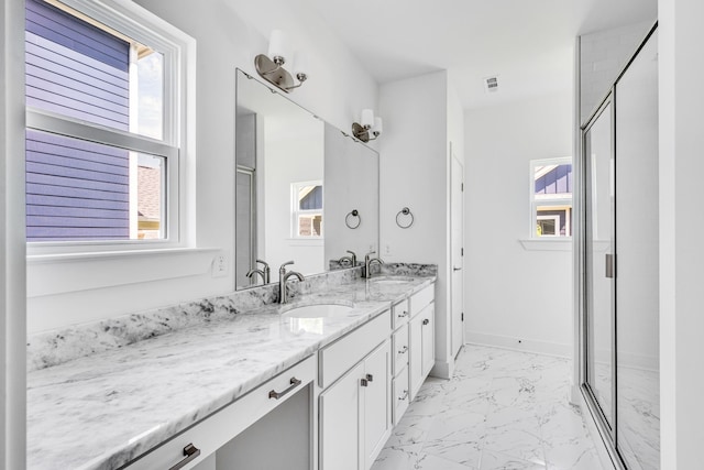 bathroom featuring plenty of natural light, large vanity, dual sinks, and tile flooring