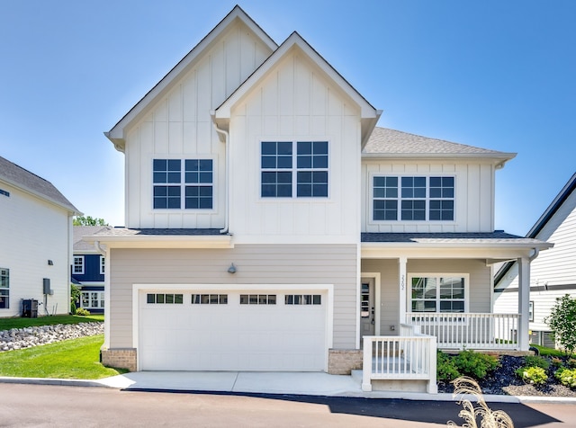 view of front of home featuring covered porch and a garage