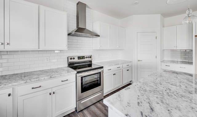 kitchen with tasteful backsplash, wall chimney range hood, decorative light fixtures, and stainless steel electric range oven