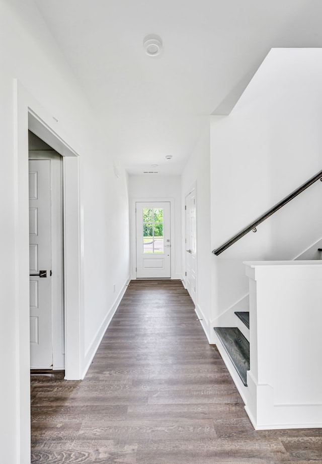 hallway with dark hardwood / wood-style floors