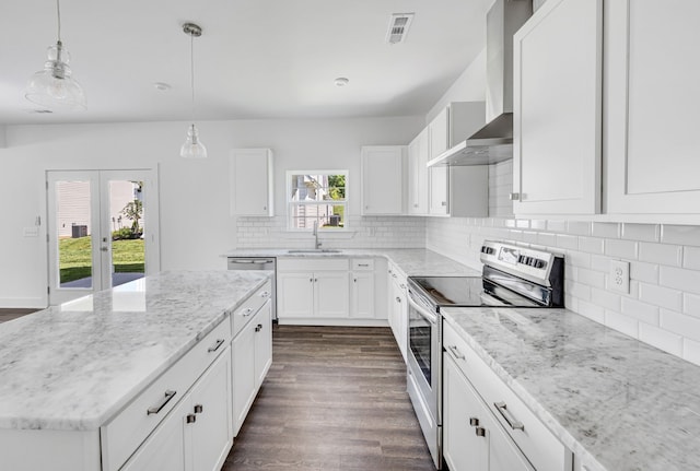 kitchen featuring wall chimney exhaust hood, dark wood-type flooring, white cabinetry, tasteful backsplash, and electric stove