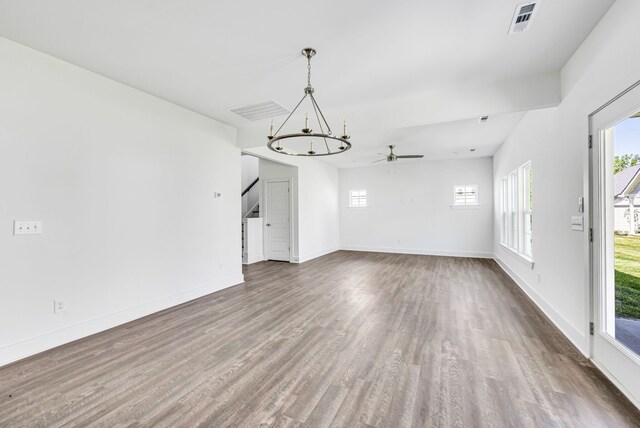 interior space featuring dark hardwood / wood-style flooring and ceiling fan with notable chandelier