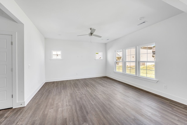 spare room with ceiling fan and dark hardwood / wood-style floors