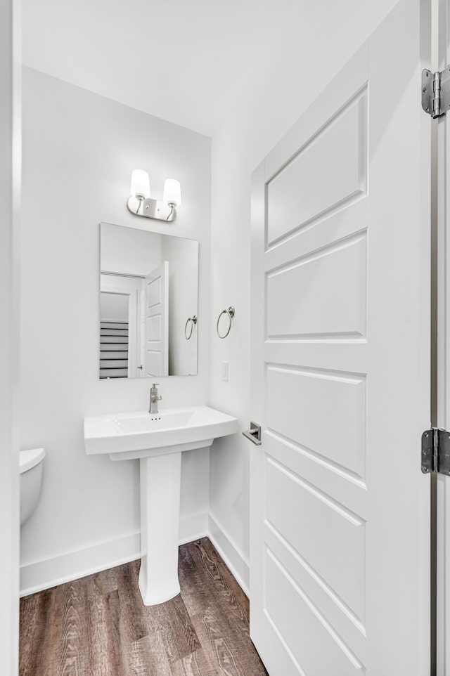 bathroom featuring hardwood / wood-style floors and toilet