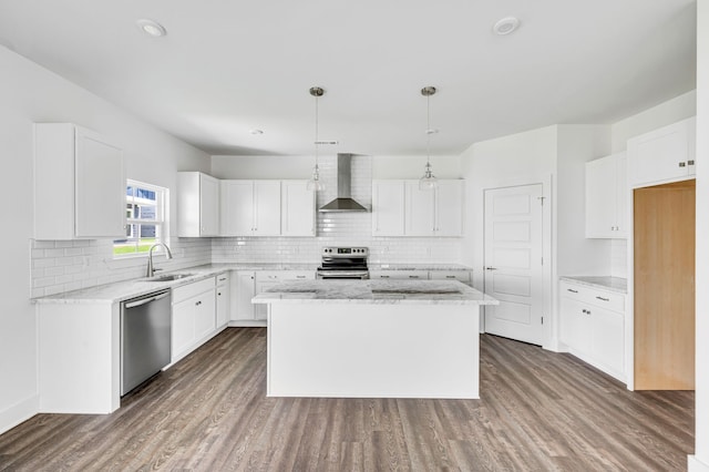 kitchen with appliances with stainless steel finishes, dark hardwood / wood-style floors, wall chimney exhaust hood, and white cabinetry