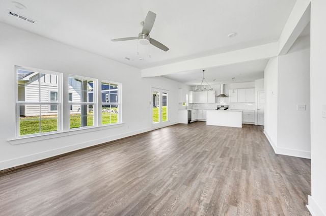 unfurnished living room featuring ceiling fan and hardwood / wood-style floors