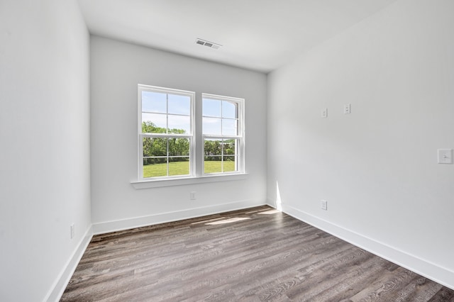 spare room with dark hardwood / wood-style floors