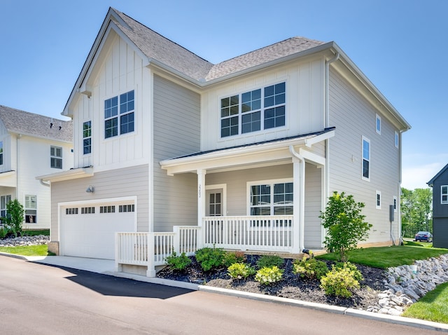 view of front of property featuring a garage and covered porch