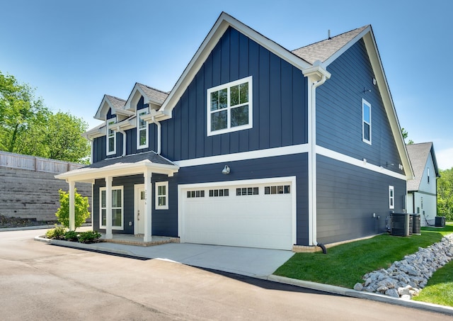 view of front of property featuring central AC and a garage