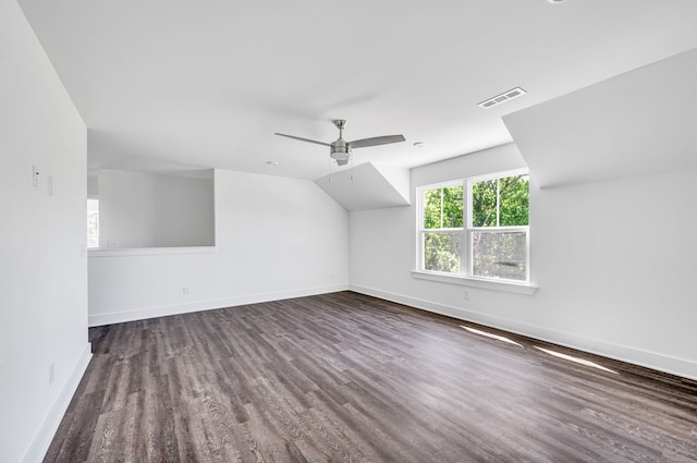 additional living space featuring dark hardwood / wood-style flooring, ceiling fan, and vaulted ceiling