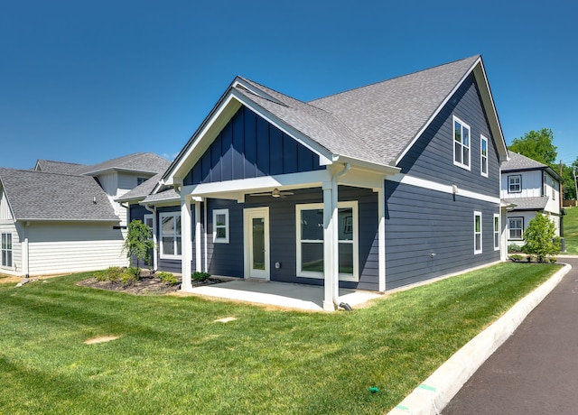 view of front of house with a front lawn, ceiling fan, and a patio area