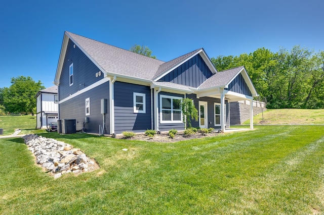 craftsman house featuring a front lawn and central air condition unit