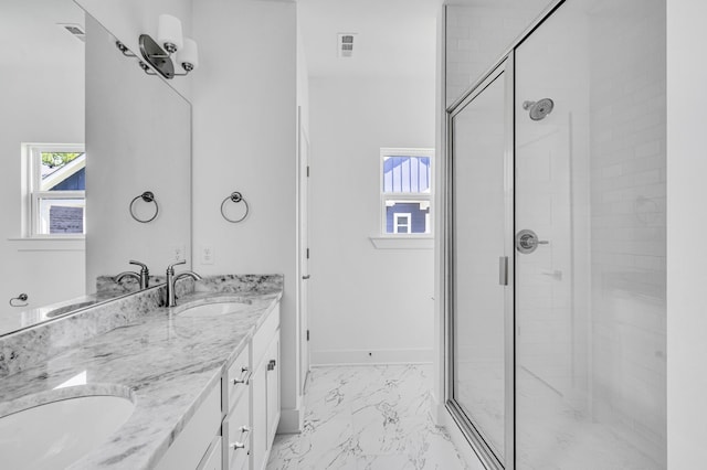 bathroom featuring a shower with door, tile floors, and double sink vanity