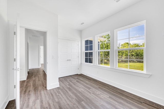 spare room with dark hardwood / wood-style flooring