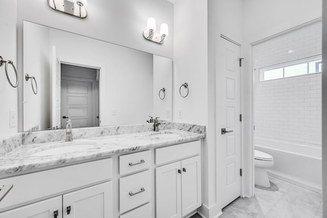 full bathroom featuring tile flooring, tiled shower / bath, vanity with extensive cabinet space, dual sinks, and toilet