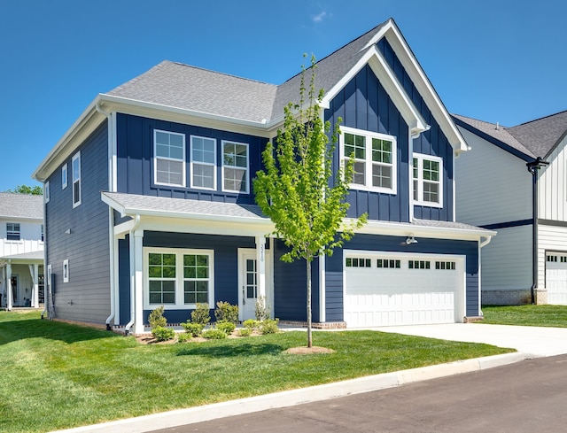 view of front of property with a garage and a front lawn