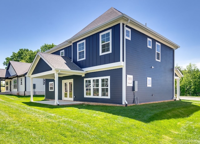 back of property with french doors, a yard, and a patio area