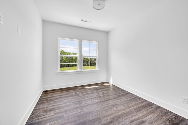 empty room with dark hardwood / wood-style flooring