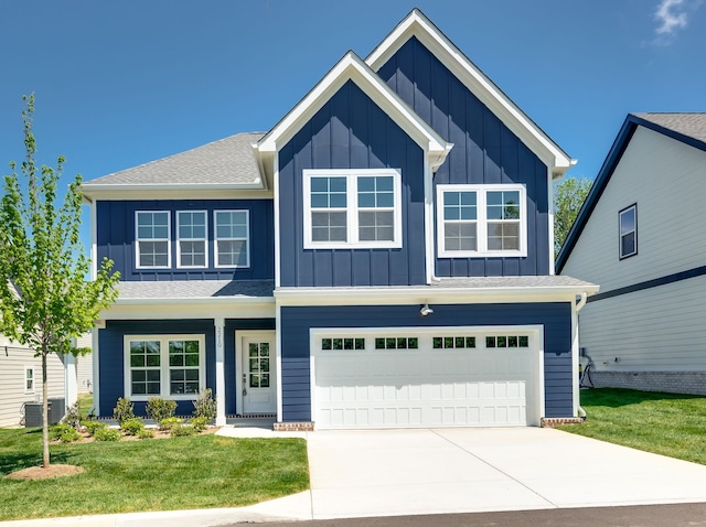 view of front of property with a garage, central air condition unit, and a front yard