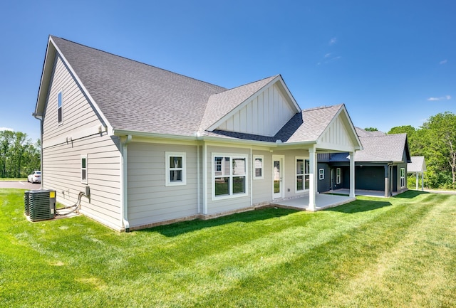 rear view of house featuring central AC, a lawn, and a patio